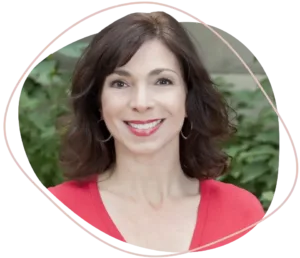 Professional portrait of Cheryl Dillon smiling confidently while seated at a mediation table, symbolizing expertise and empathy. Looking for compassionate guidance through your divorce? Call Equitable Mediation at (877) 732-6682 to connect with Cheryl today.